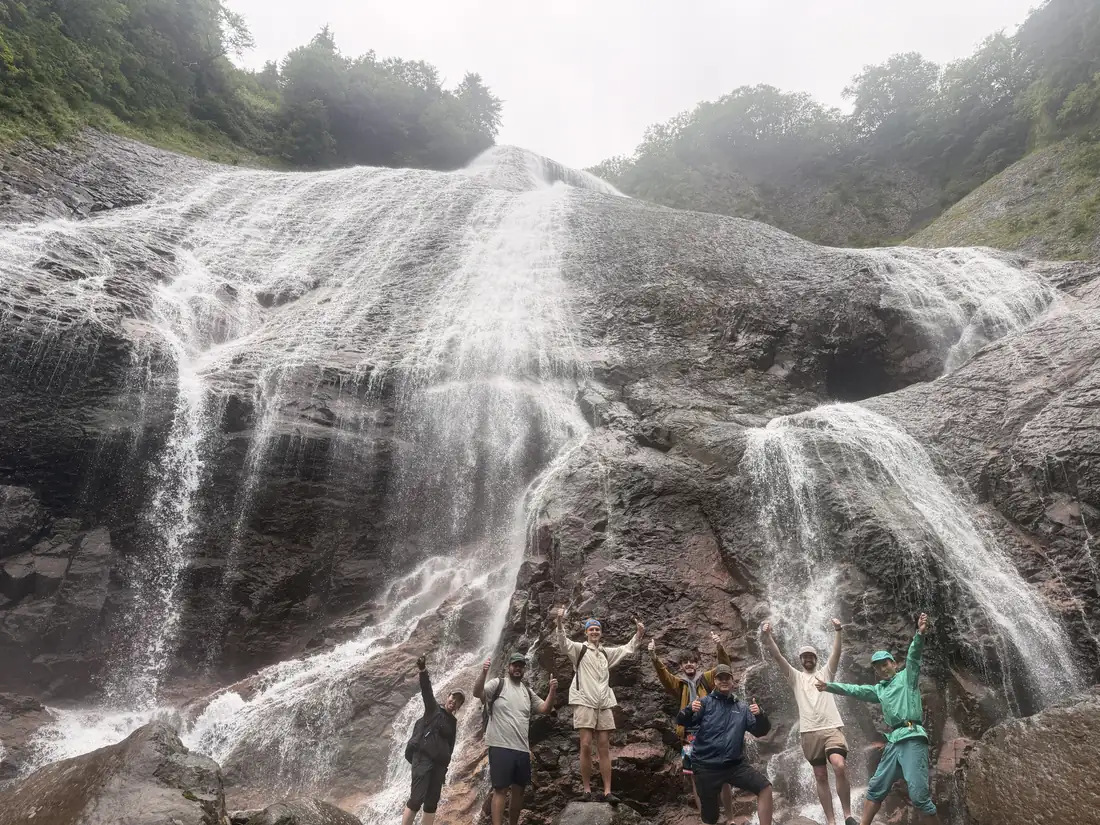 Namekawa Great Falls, an 80-metre cascade, with hikers at its foot