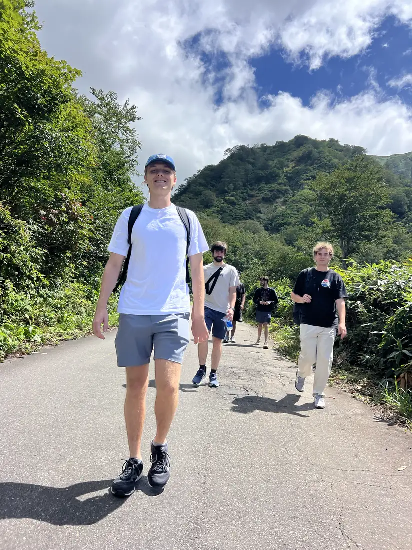 Travelers walking the approach to Yudonosan shrine